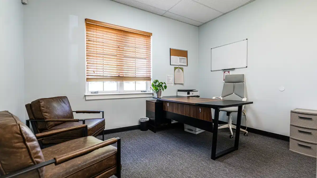 Clinician and client talking in a bright therapy office